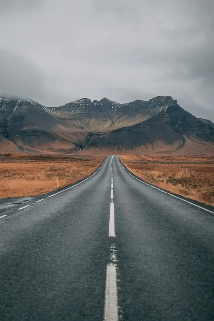 Mountain road under cloudy sky in landscape